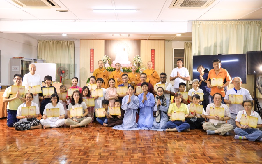 Participants and monks with certificates after the Refuge Ceremony