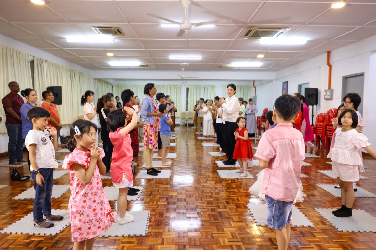 Families and children practising together in the meditation hall